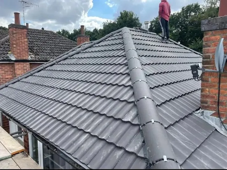 Hipped roof re-tiled with dry ridge near Glossop