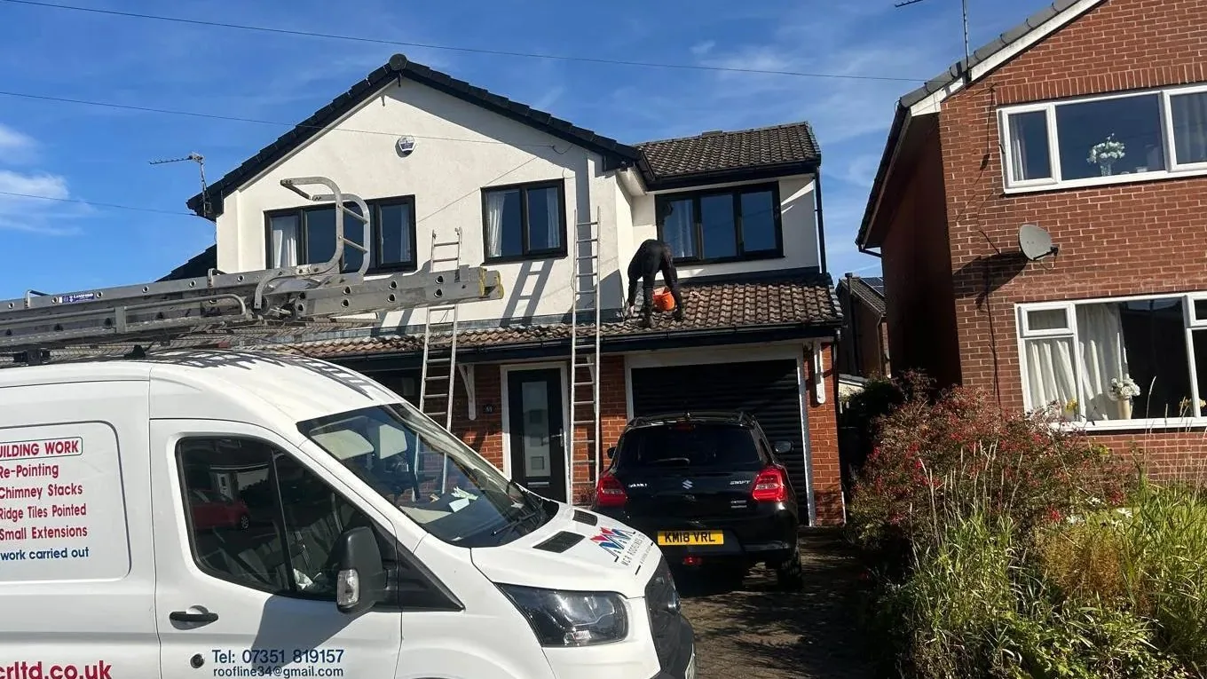 Roofer inspecting a roof in Ashton-under-Lyne