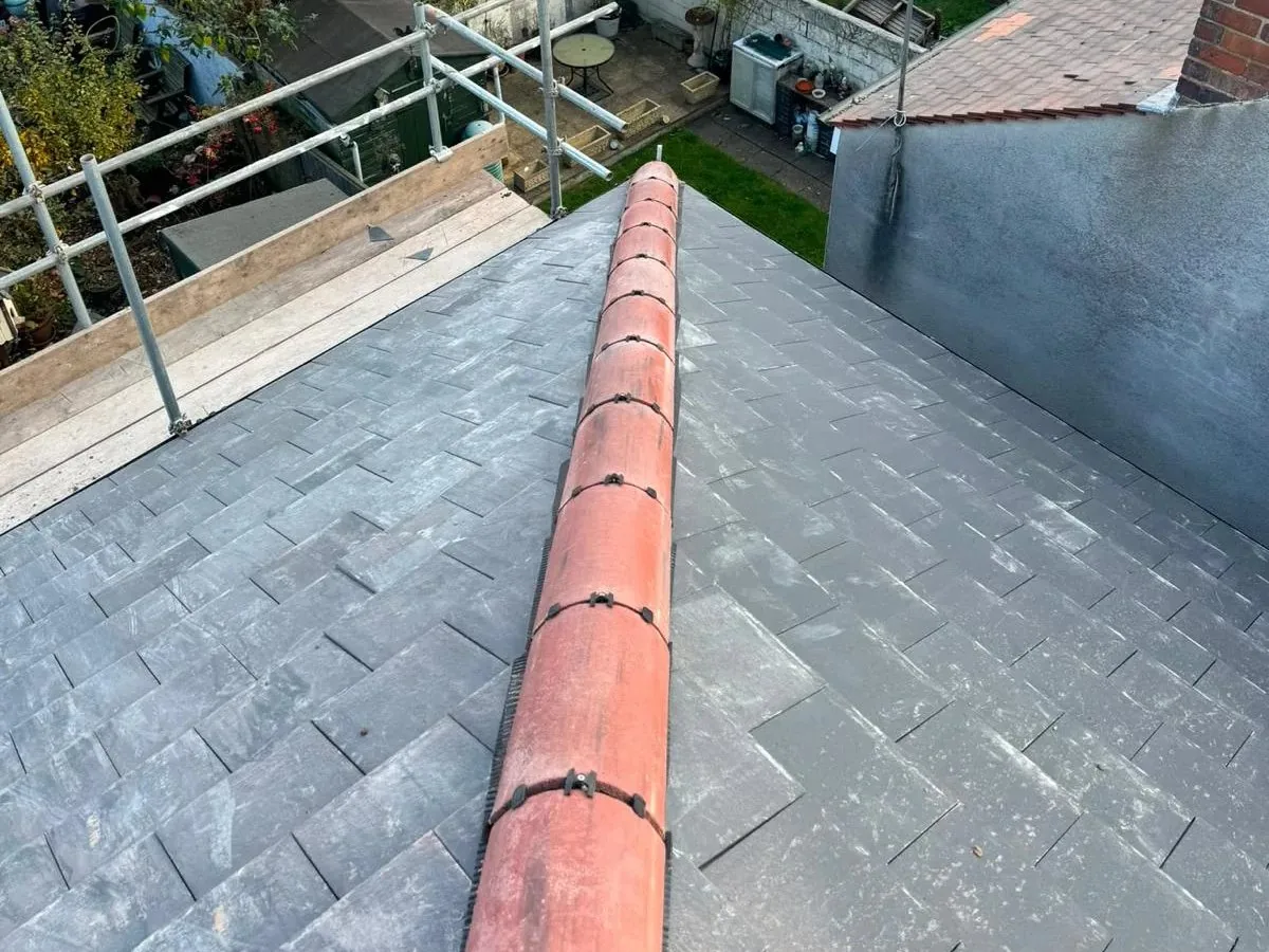 Slate roof in Hyde with new ridge tiles after a repair