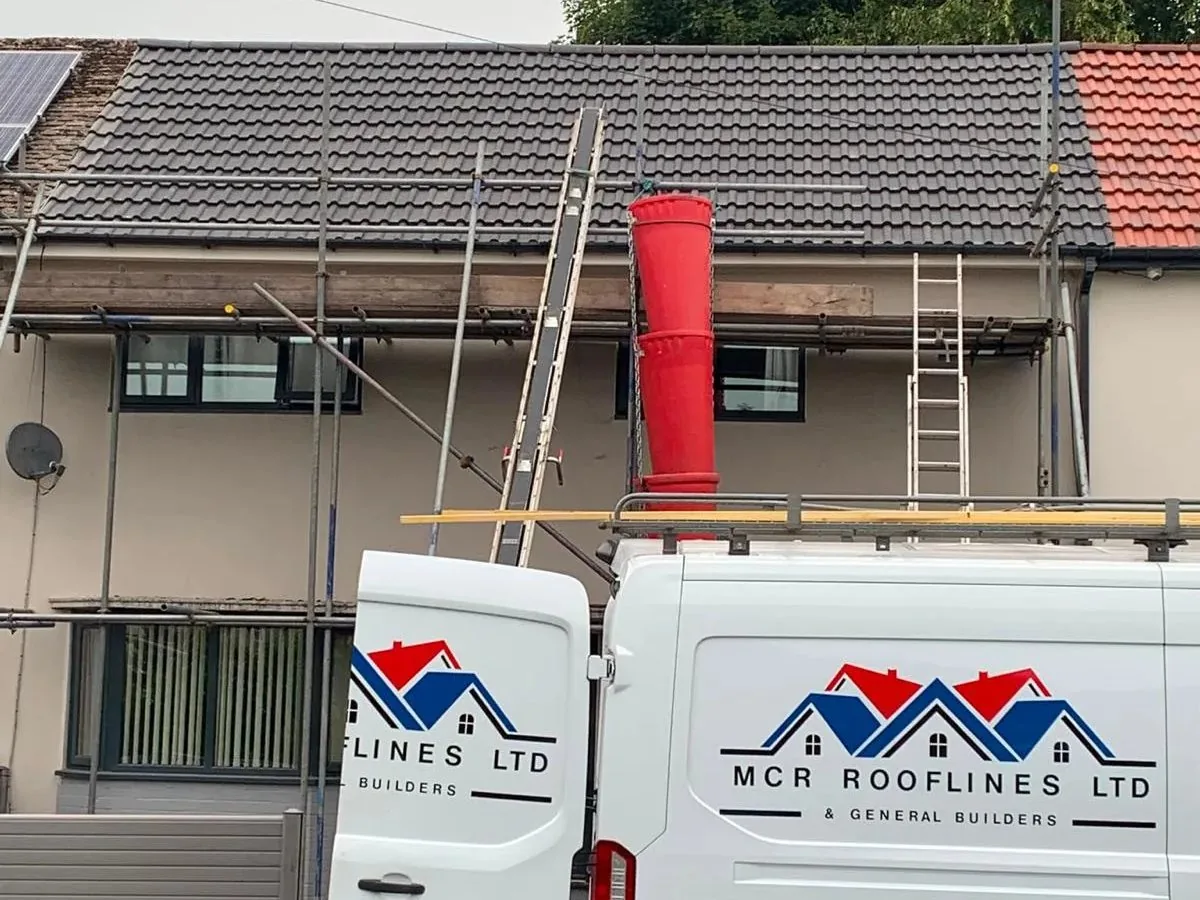 MCR Rooflines re-tiling a roof with scaffold and chute